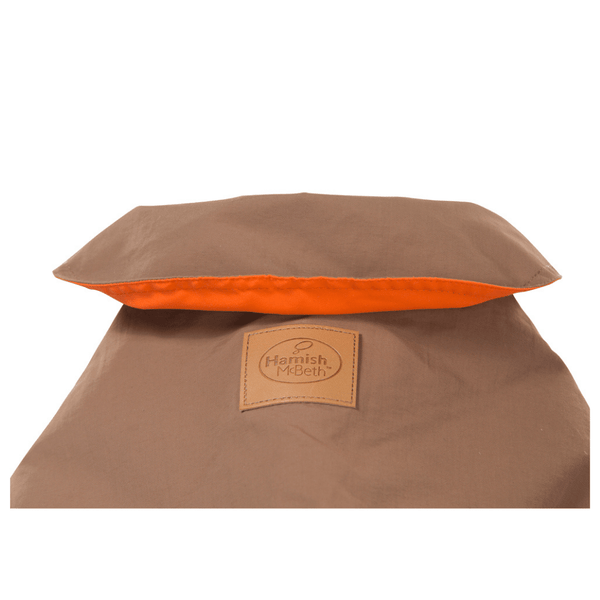 Hamish McBeth earth brown all-weather dog coat is windproof and water-resistant with orange highlights is an outdoor gear essential. The unique design of our dog coat allows it to wrap around the chest area to cover and provide extra protection. Easy to fit with velcro straps on top. and is fully quilted for extra warmth. Available in 6 sizes for small  to large dogs.