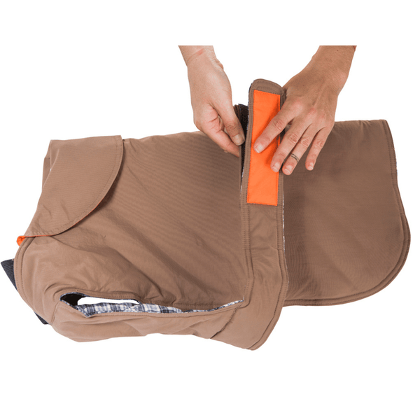 Hamish McBeth earth brown all-weather dog coat is windproof and water-resistant with orange highlights is an outdoor gear essential. The unique design of our dog coat allows it to wrap around the chest area to cover and provide extra protection. Easy to fit with velcro straps on top. and is fully quilted for extra warmth. Available in 6 sizes for small  to large dogs.
